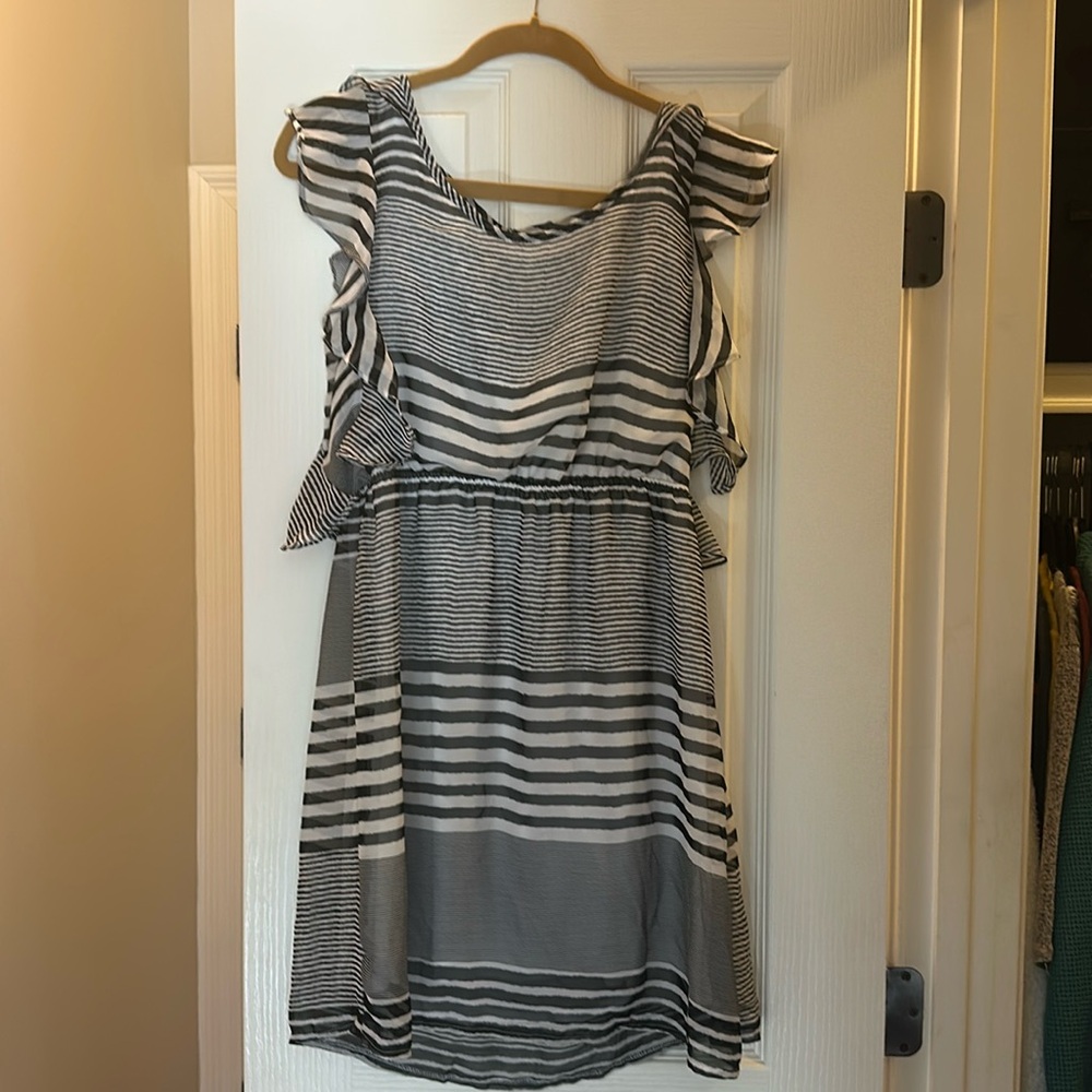 Round neck black and white ruffle cap sleeve dress. Sits just above the knee